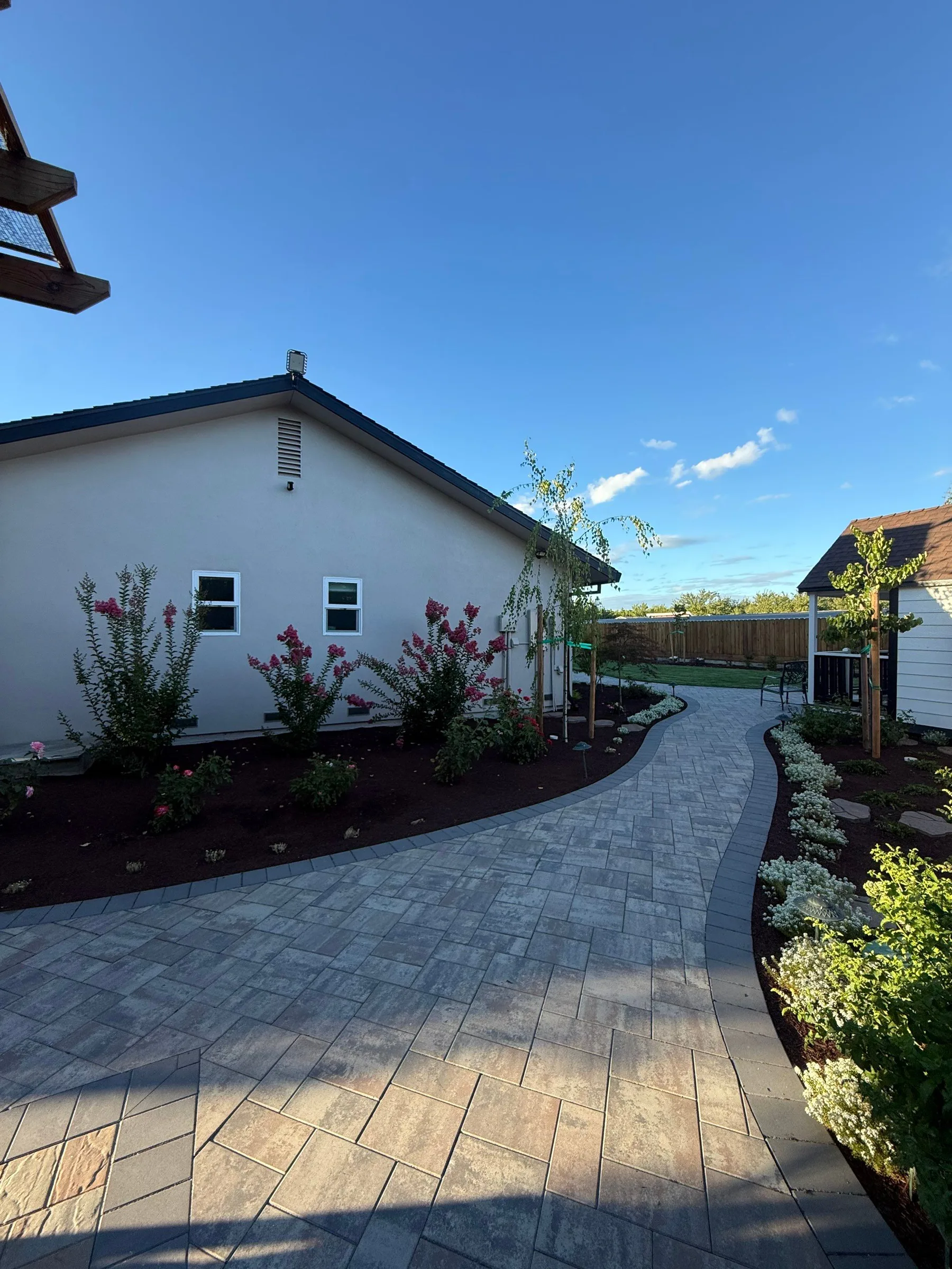 Paver path creating a finished route through a narrow side yard