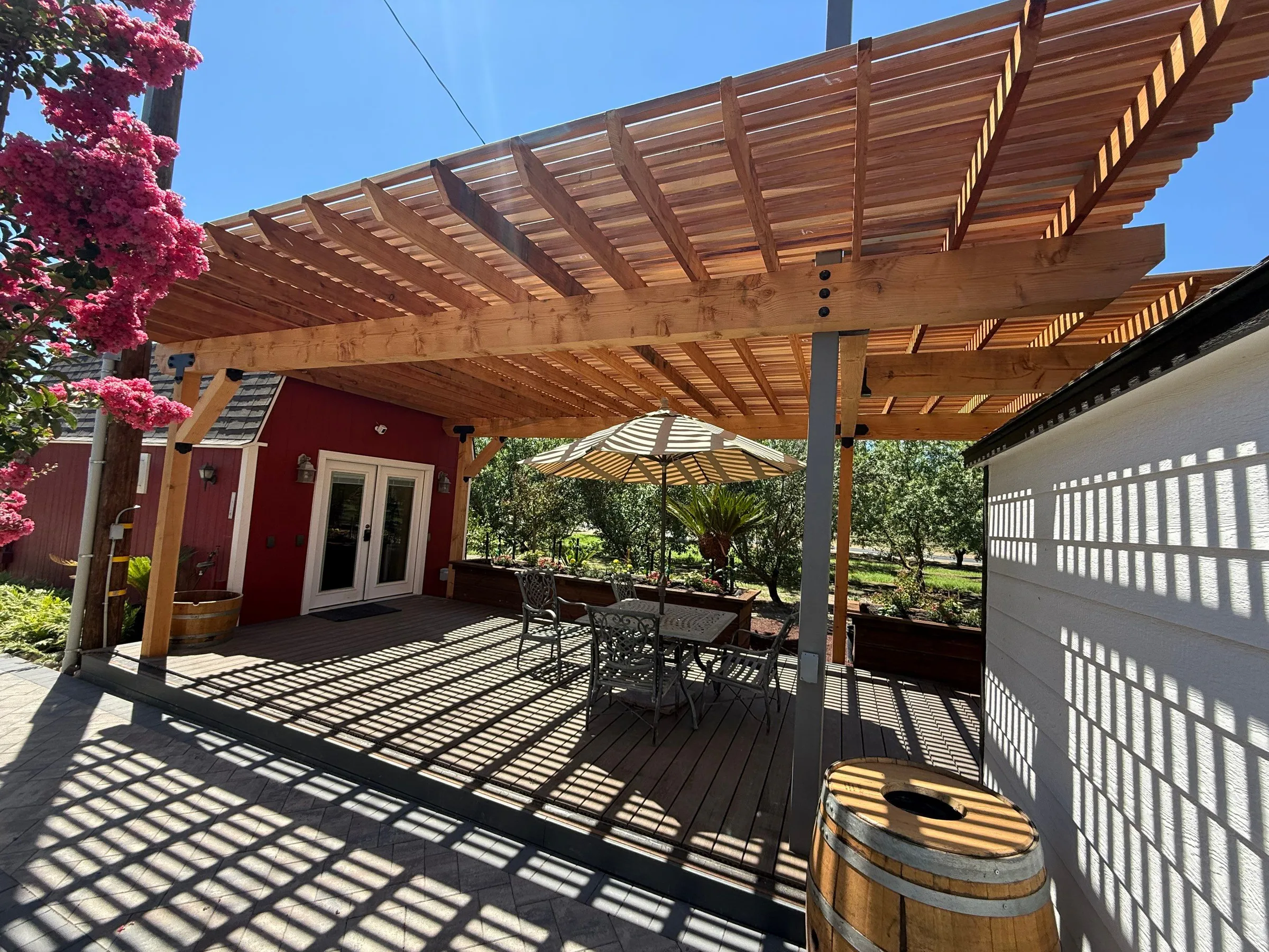 Wood pergola creating shade above a finished outdoor patio